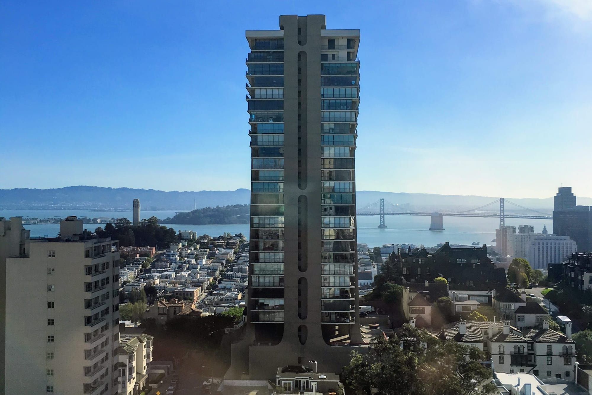 The Summit tower on Russian Hill with the Bay Bridge and the bay behind it