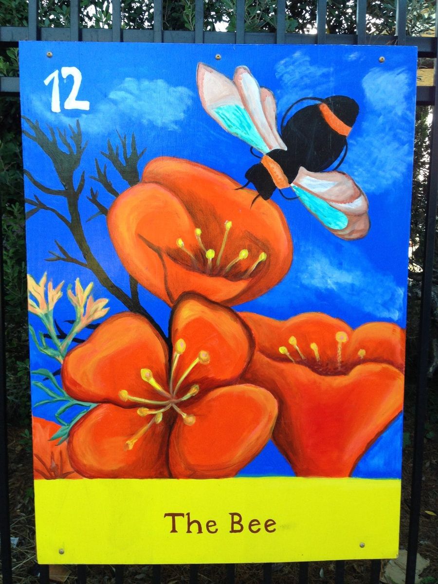 A painted community art panel of a bee and California poppies in the Excelsior