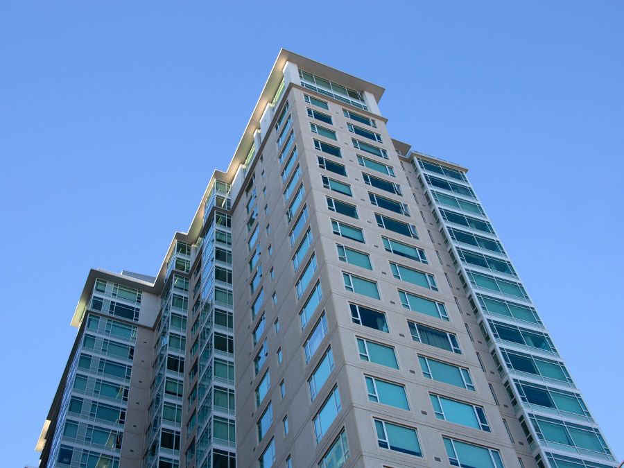 The SOMA Grand tower against a blue sky, seen from Mission Street