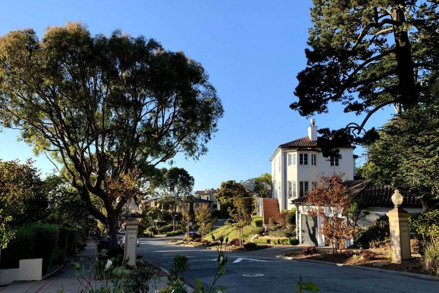 A curving, tree-lined street of large homes in St. Francis Wood