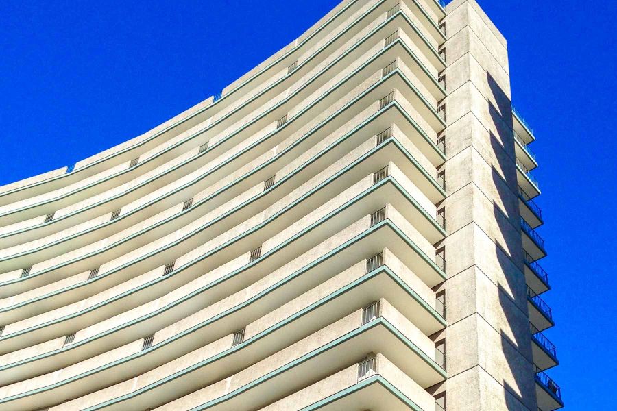 The curved balconies of the Fontana towers against a blue sky