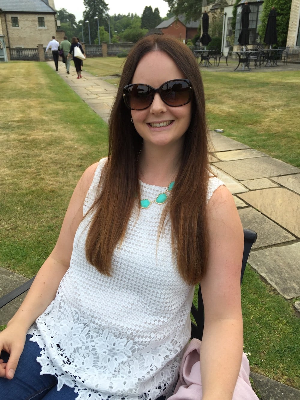 Aimi sat outside on a sunny day with sunglasses on