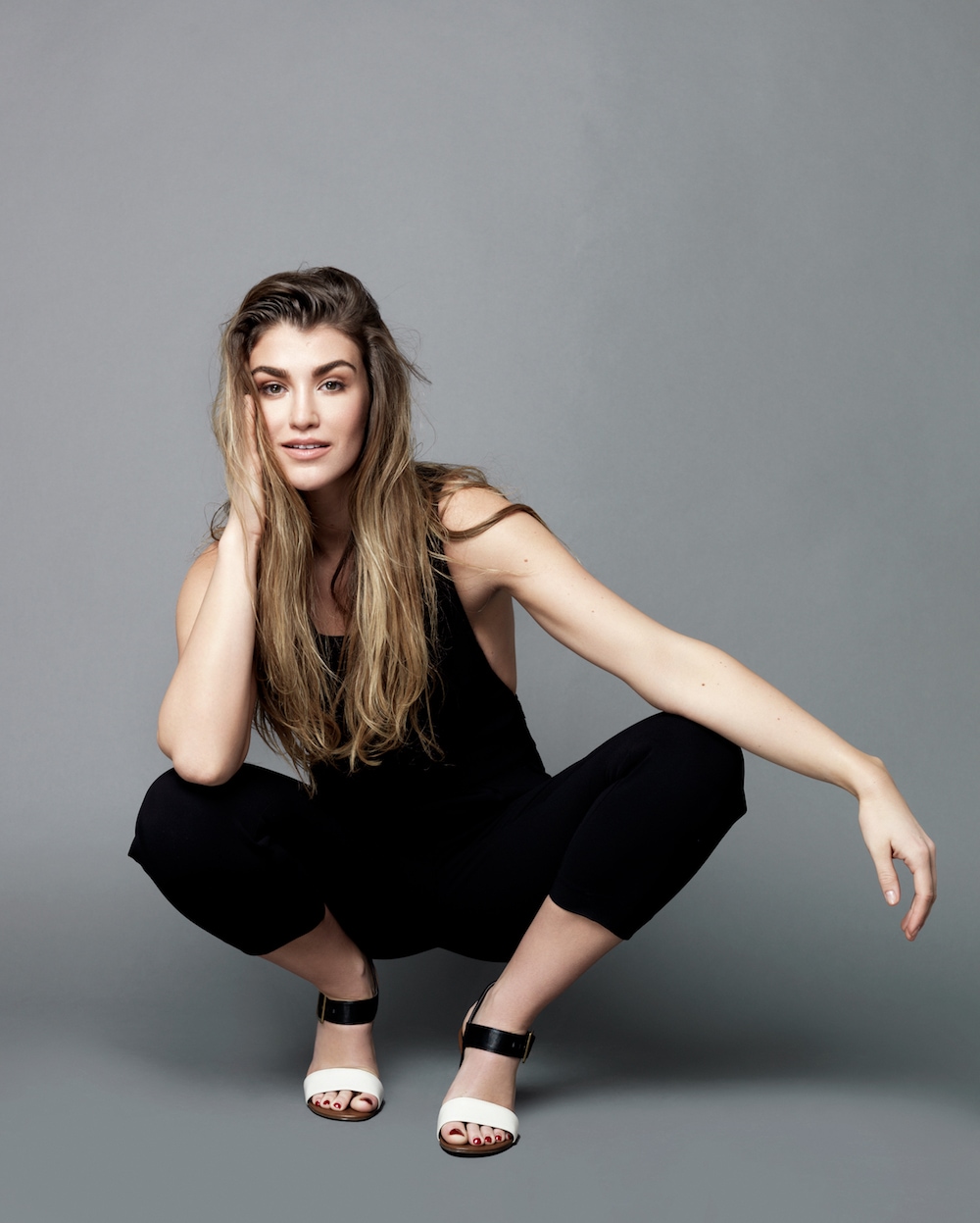 This is a photo of Amy kneeling down and smiling at the photoshoot