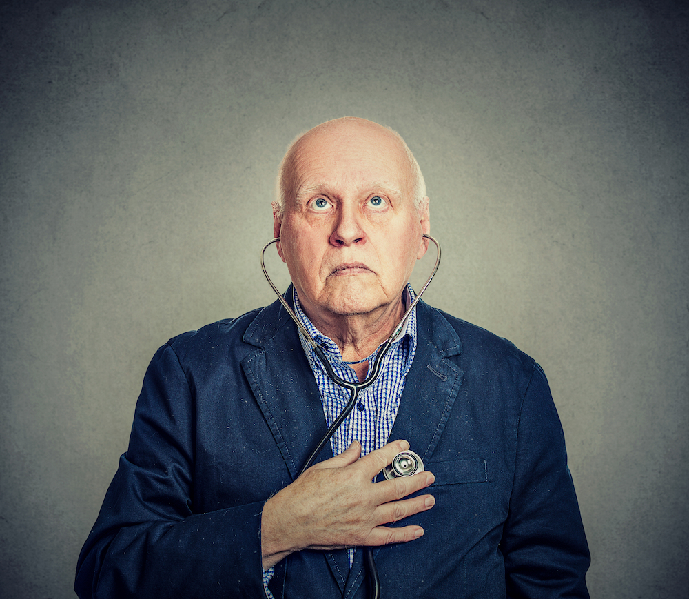 Old man listening to his own heartbeat