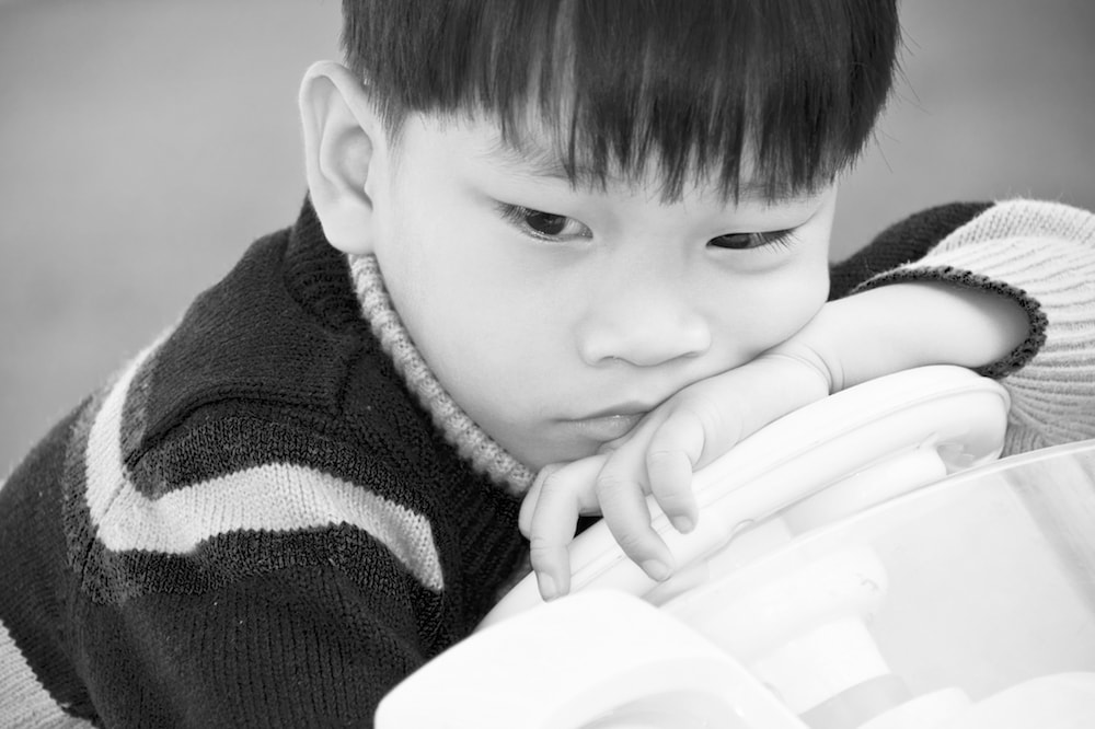 A young boy looking upset