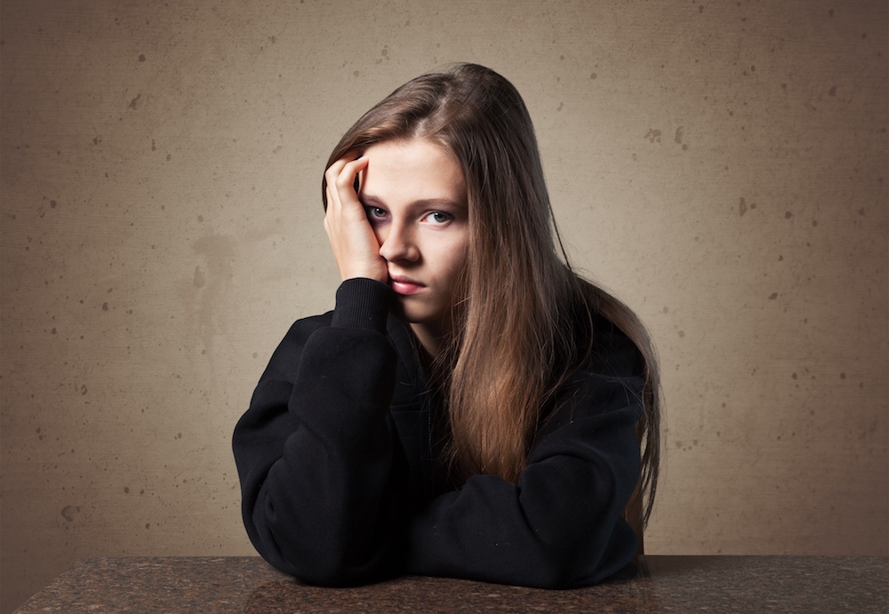 A young girl looking upset