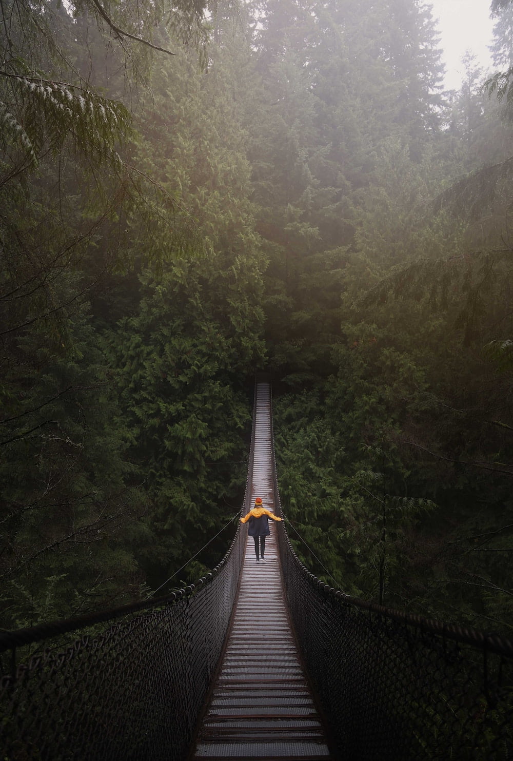 woman crossing a rope bridge