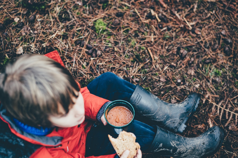 boy eating soup and bread