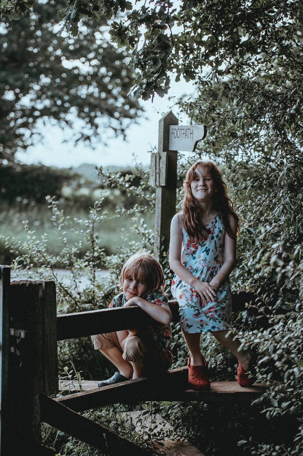 children sitting together in woods