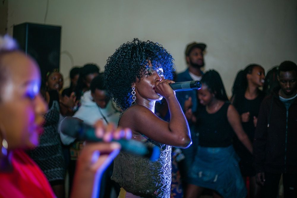 two women singing and smiling