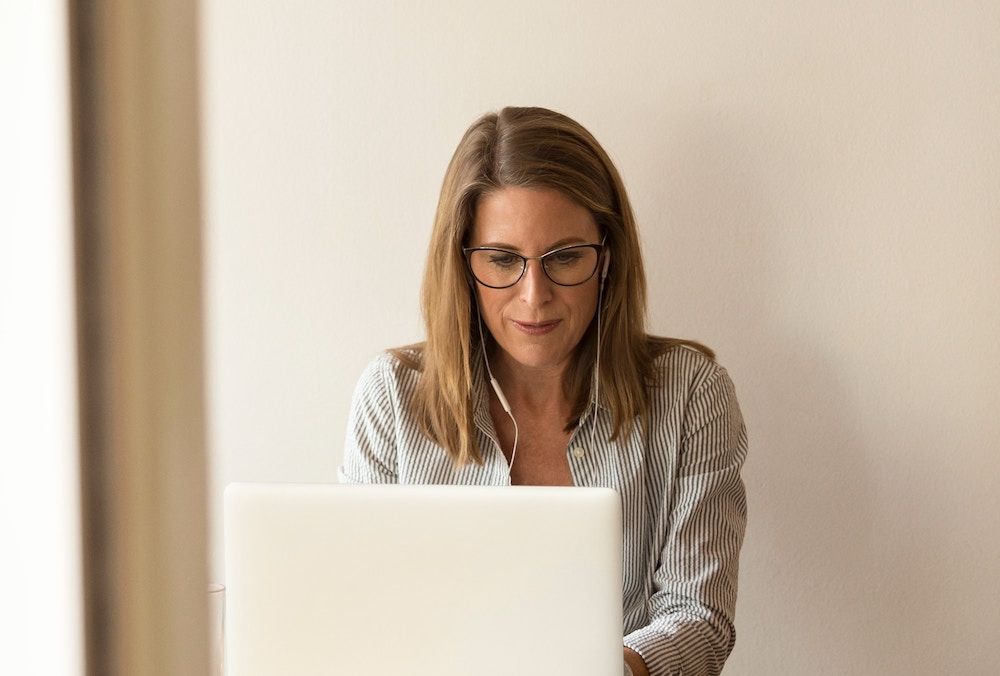 woman sitting in front of laptop