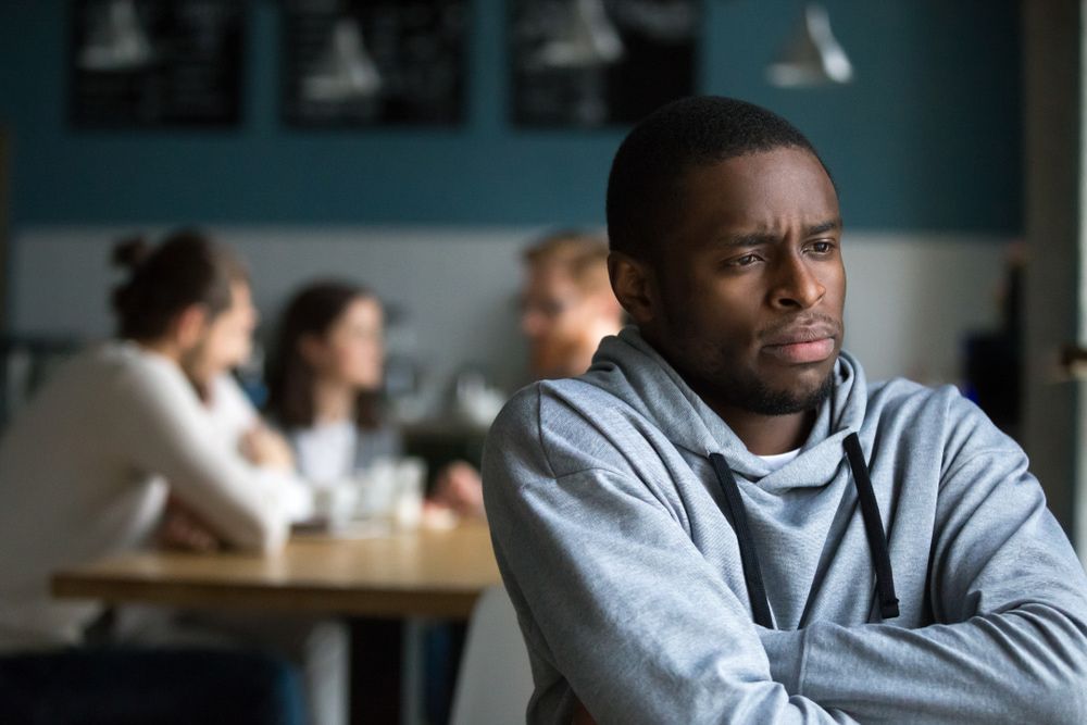man sitting near group of people