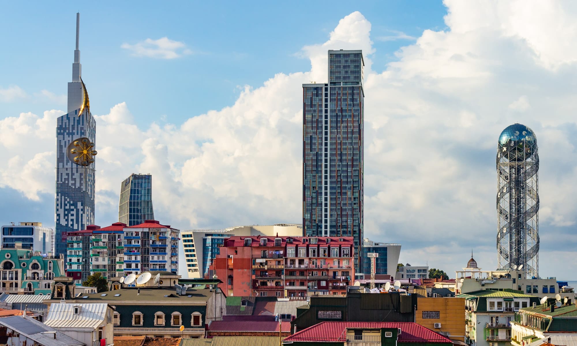 Batumi skyline with unique towers – Panoramic view of Batumi, featuring the Alphabetic Tower and the high-rise with a Ferris wheel-style clock embedded in its facade.