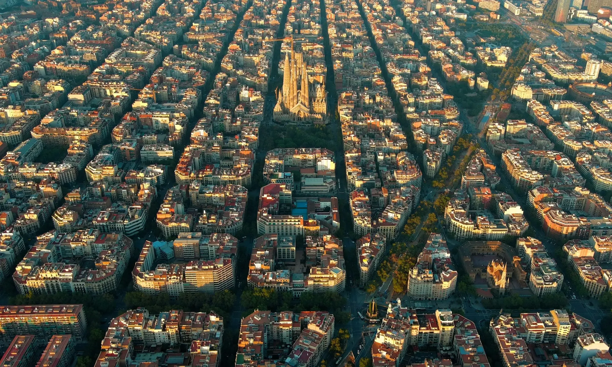 Aerial view of Barcelona’s Eixample district with its distinctive grid layout, centered on the Sagrada Família basilica.
