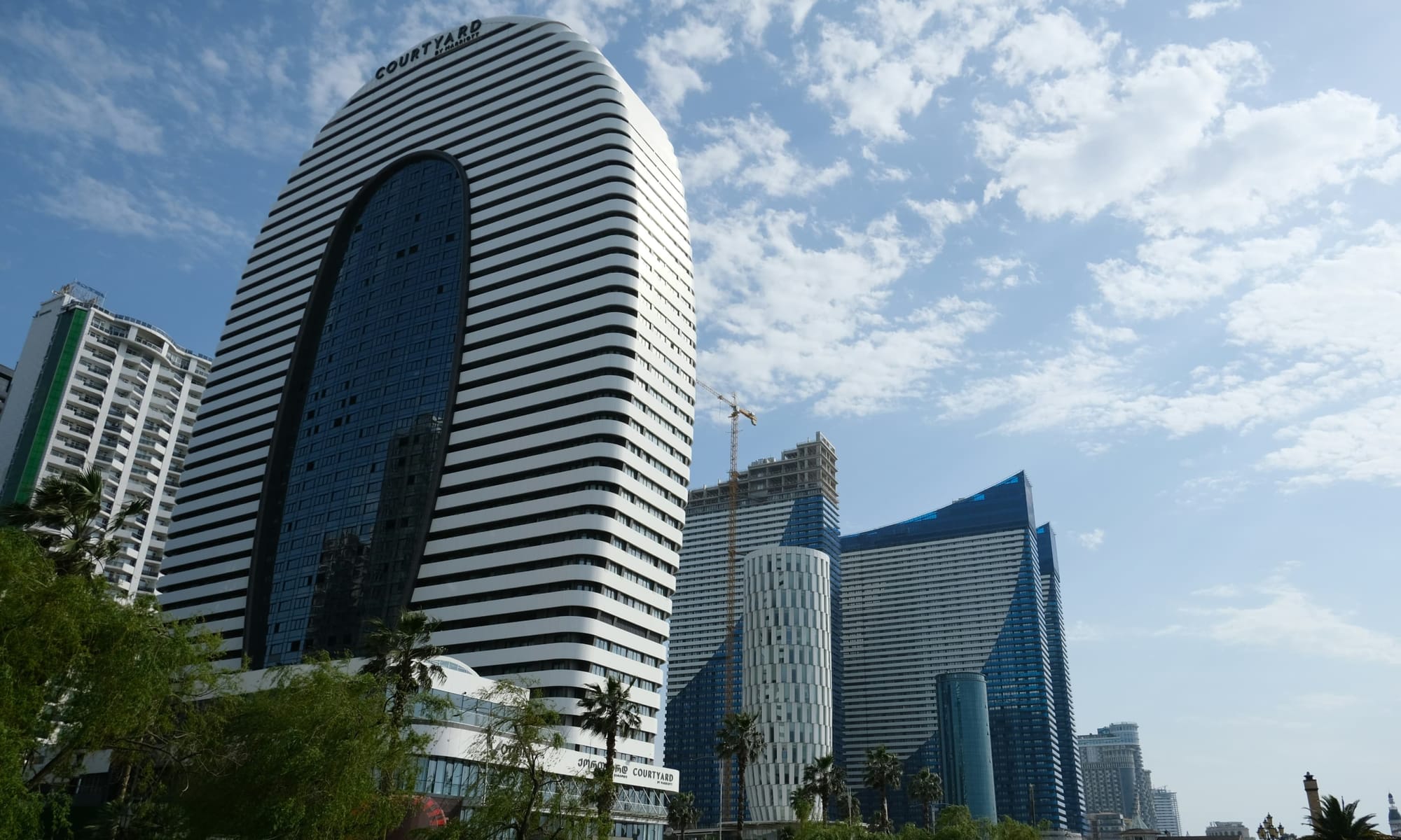 Courtyard by Marriott Batumi tower – Close-up of the distinctive Courtyard by Marriott tower in Batumi, Georgia, surrounded by other modern high-rise developments.