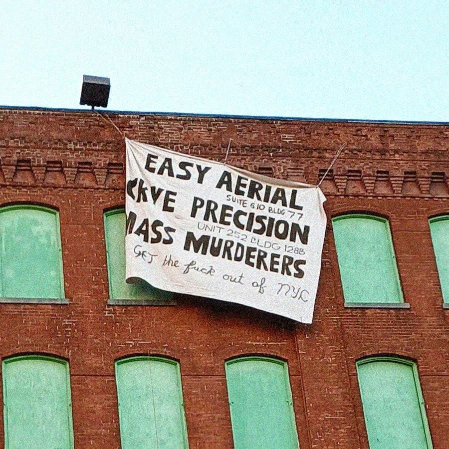 Banner drop exposes 2 war profiteers in Brooklyn, NY