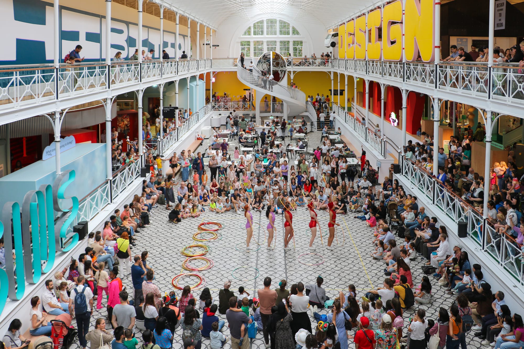 People gather in a large hall for a performance