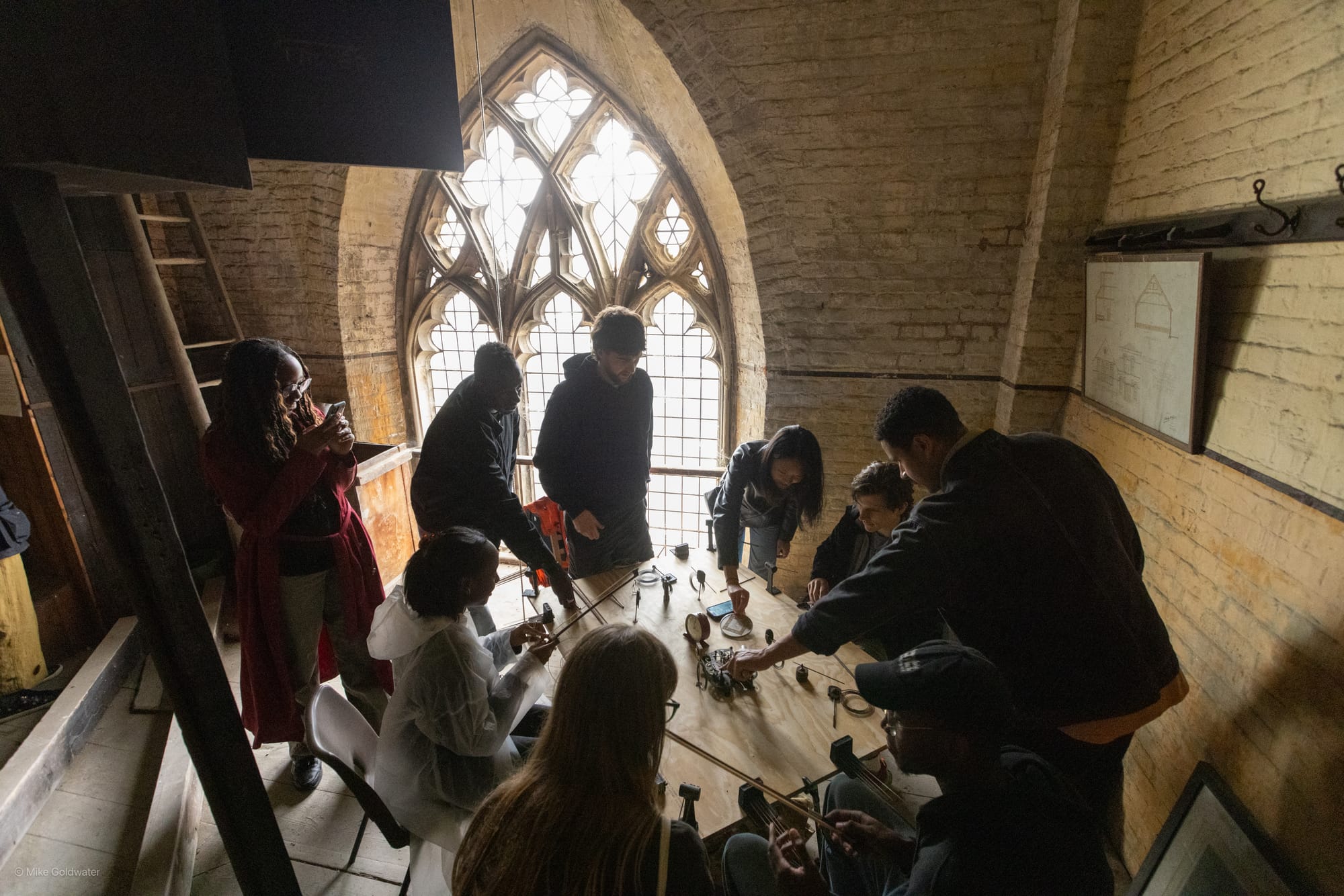 People stand around a table in a church tower