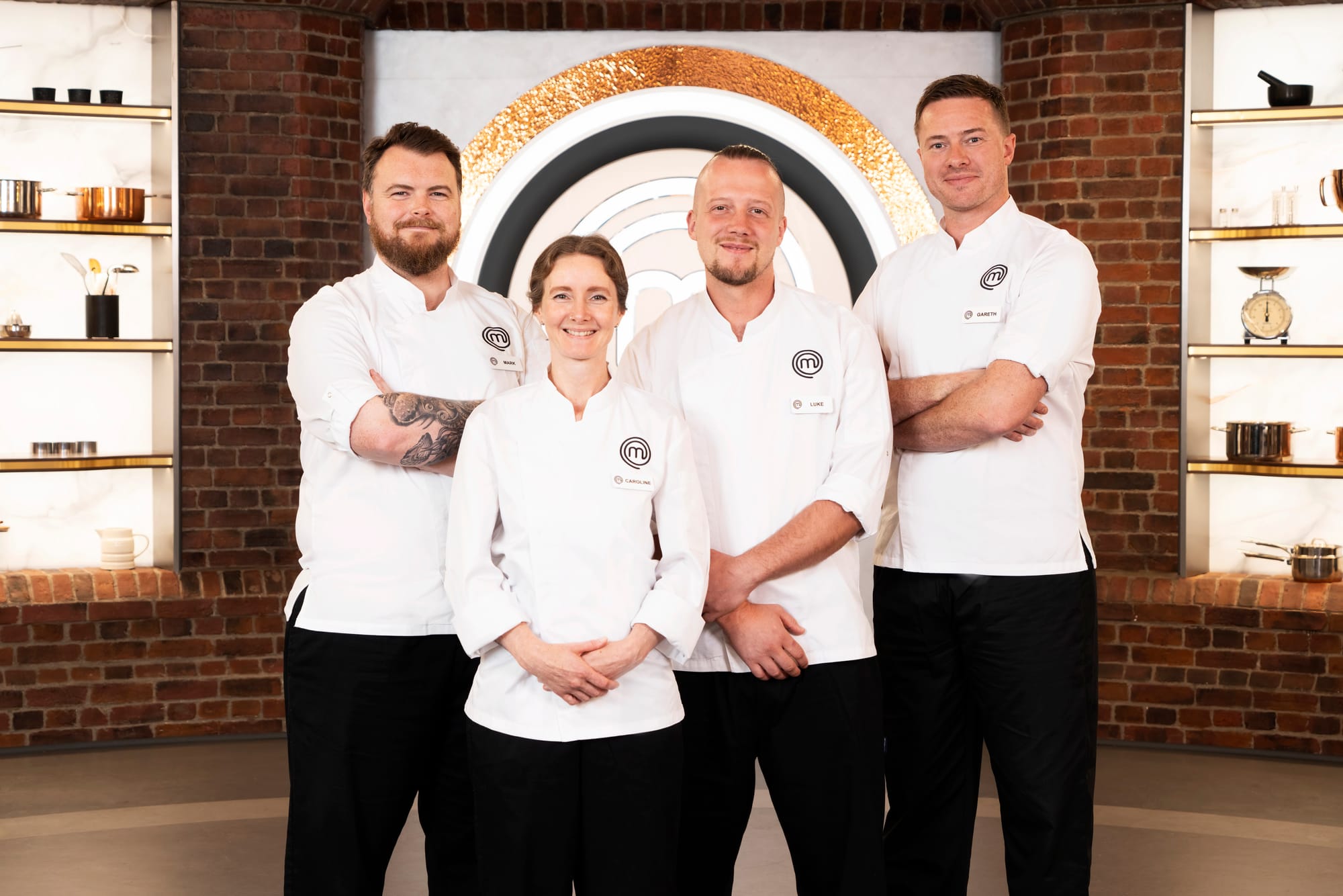 Three male and a female chef standing together in a TV studio