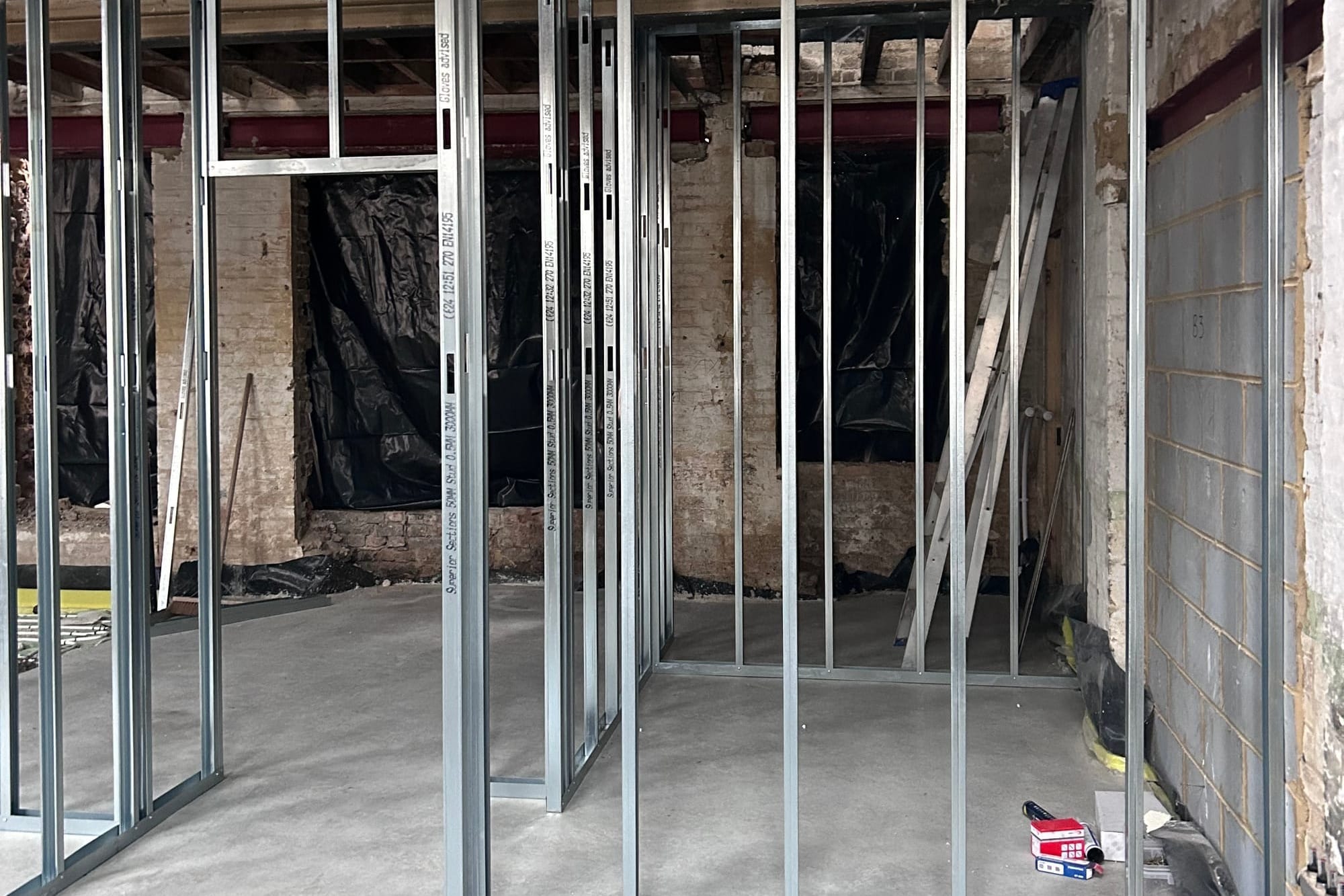 A residential construction site with metal pole errected