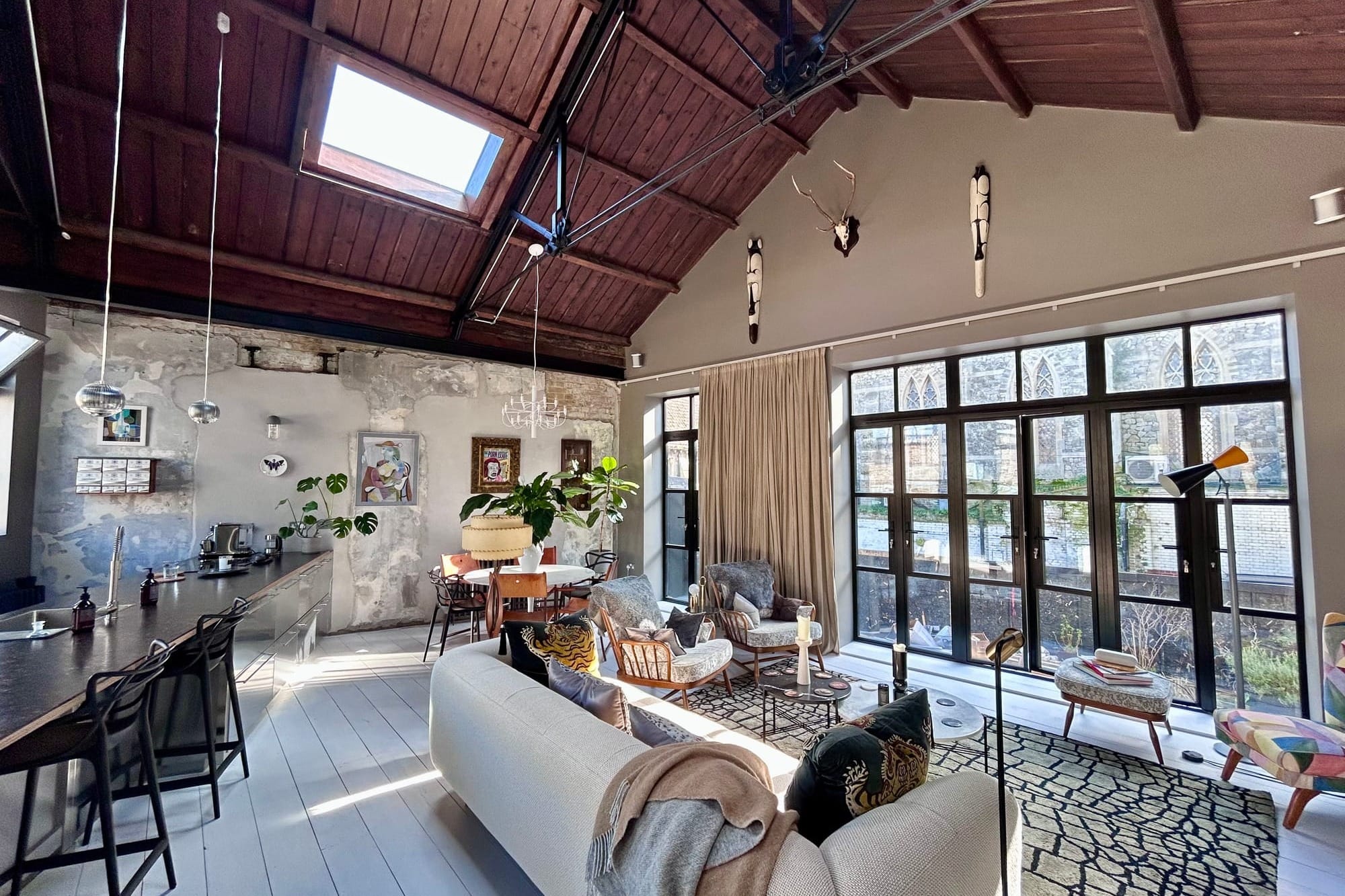 An open-plan living area decorated in mid-century furnishings