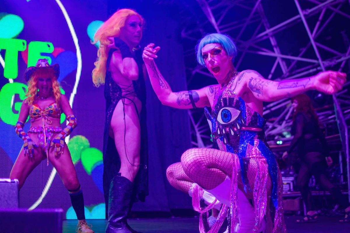 Drag queens dance on stage