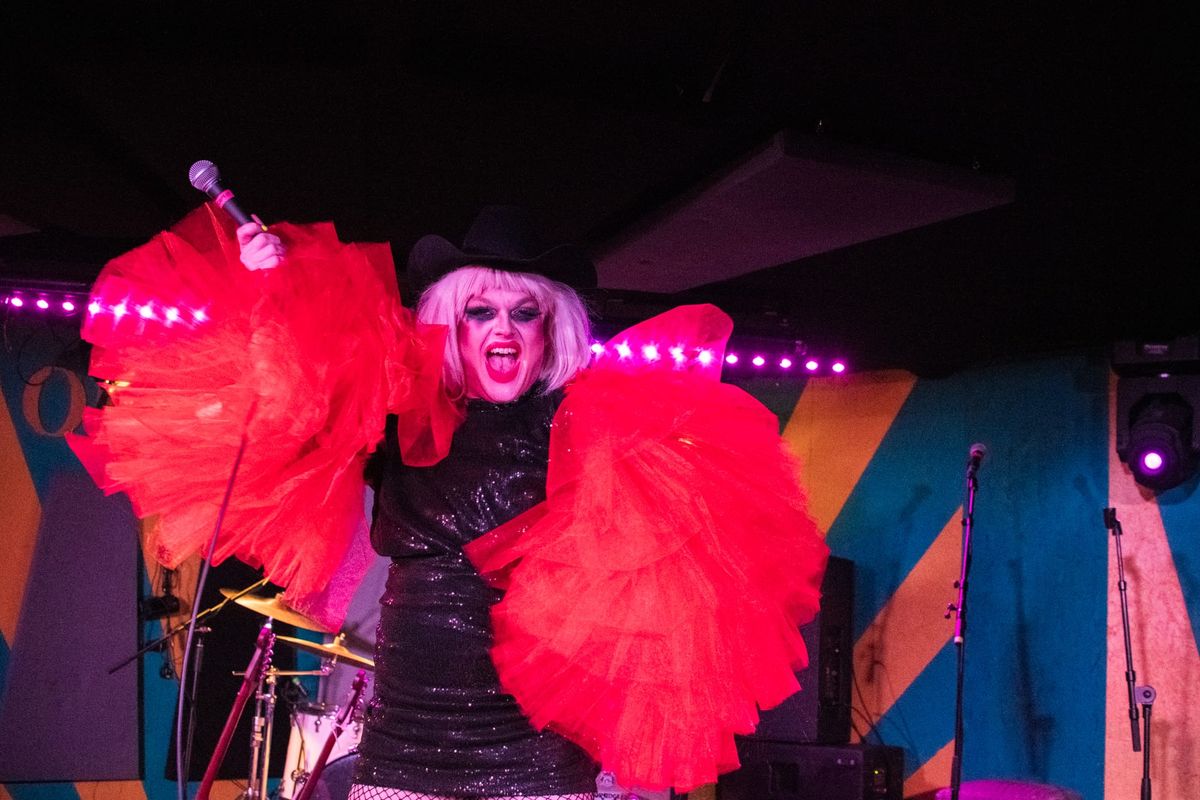 A drag queen performs on stage