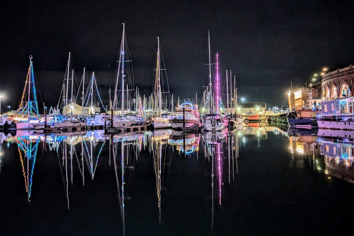 Boats in Ramsgate Harbour illuminated with Christmas lights