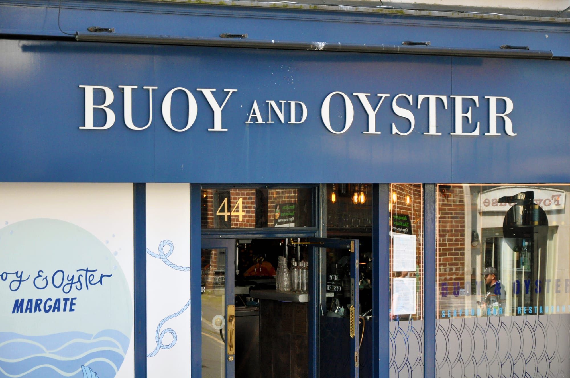 The blue frontage of a restaurant called Buoy and Oyster