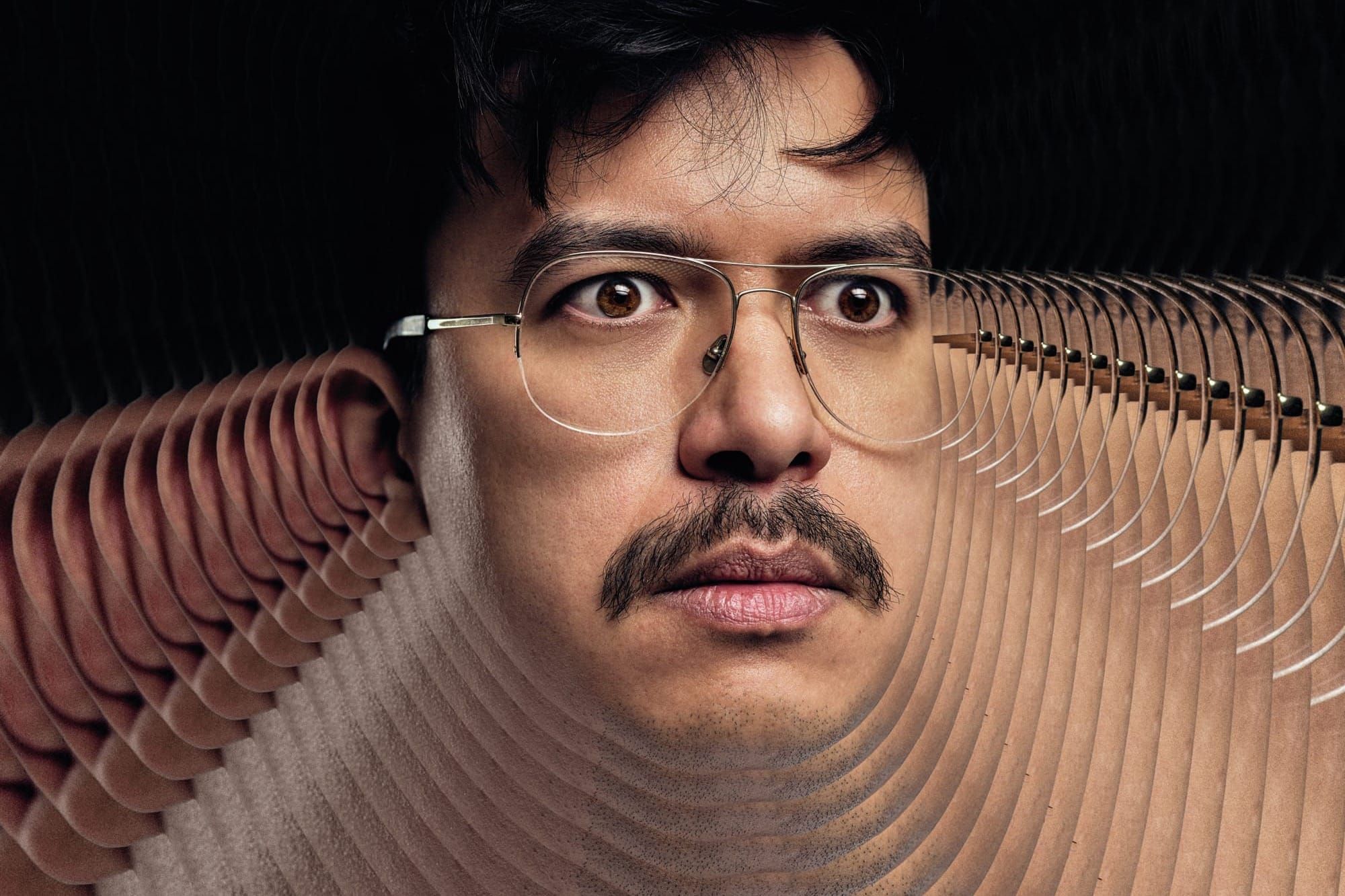 A man with glasses and a moustache