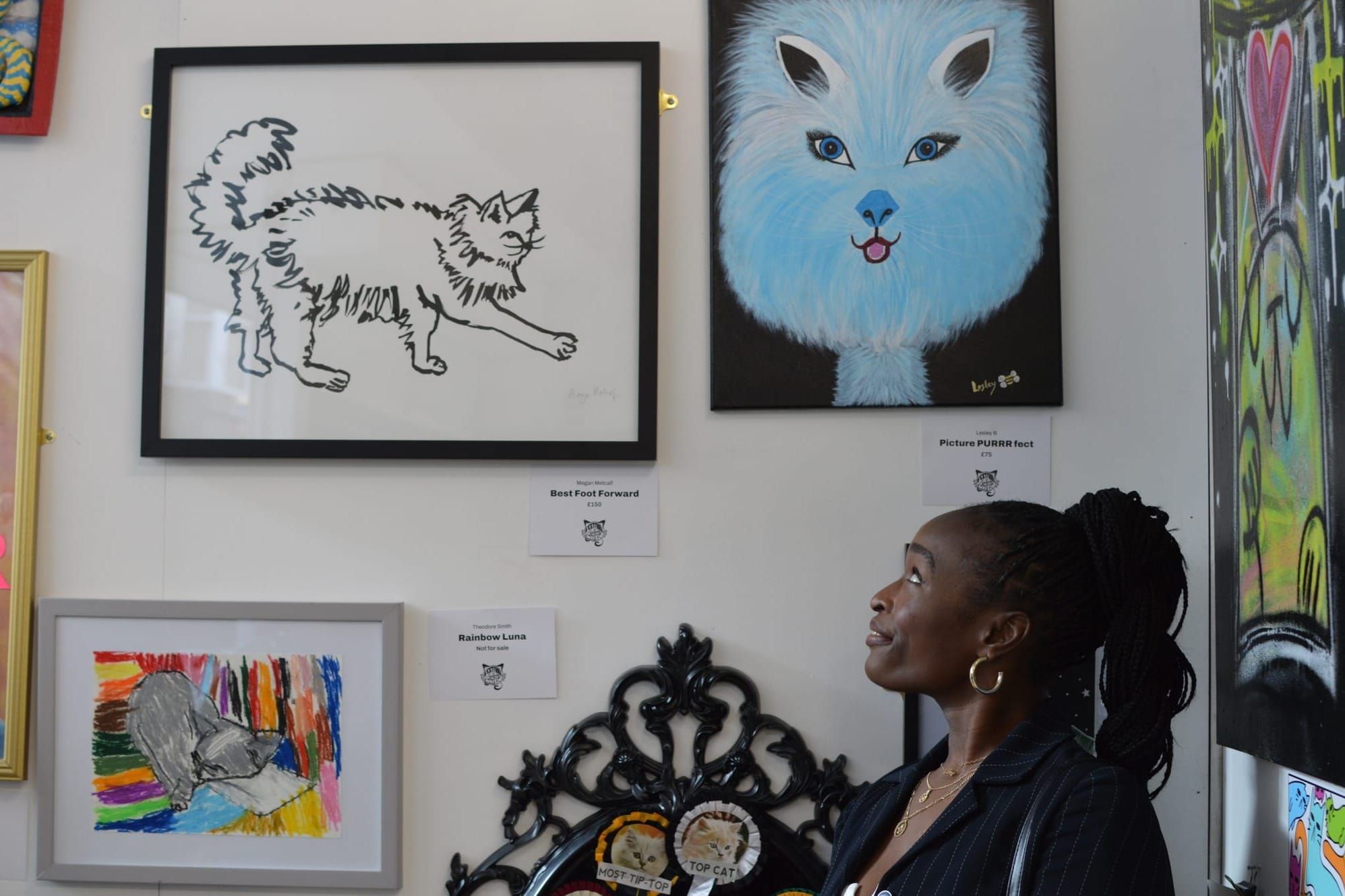 Woman looking at an artwork of a cat