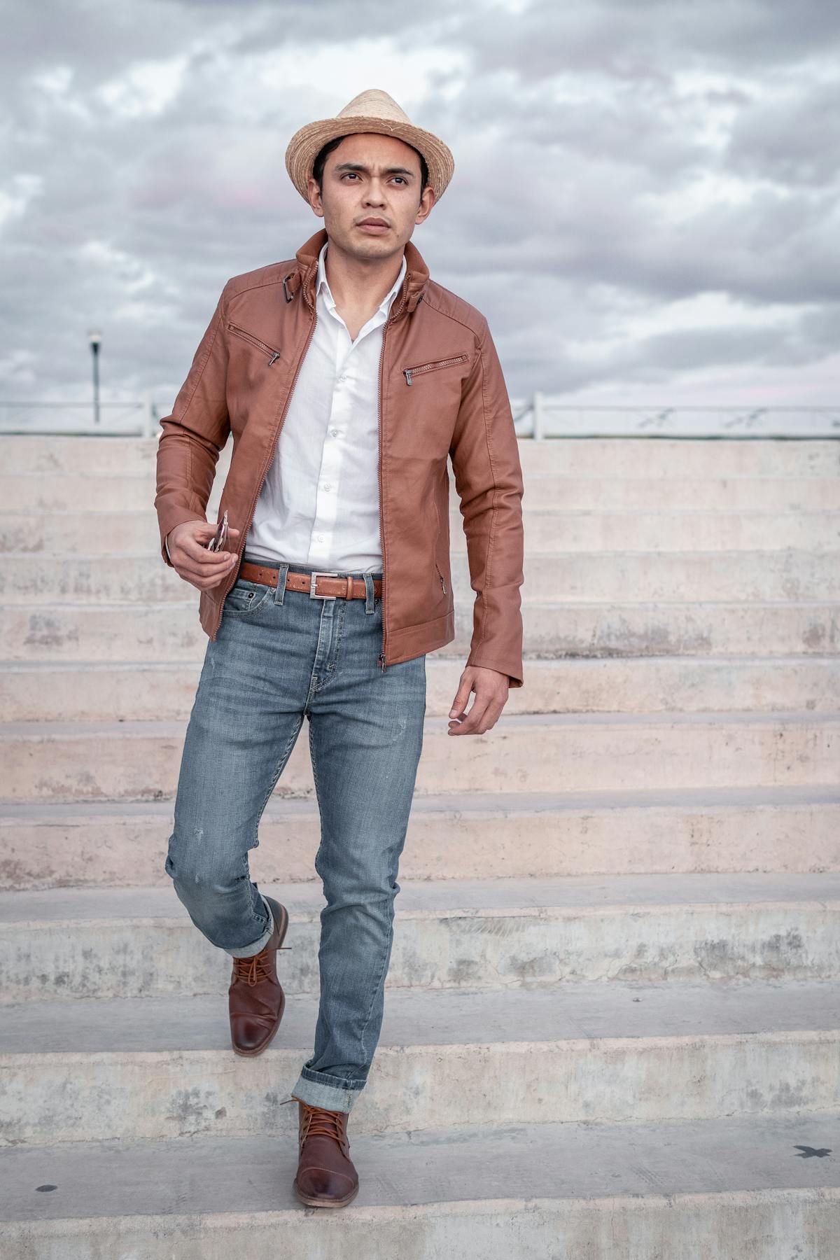 Man in light leather jacket over button-down with jeans, the smart casual layer for 62 degree weather