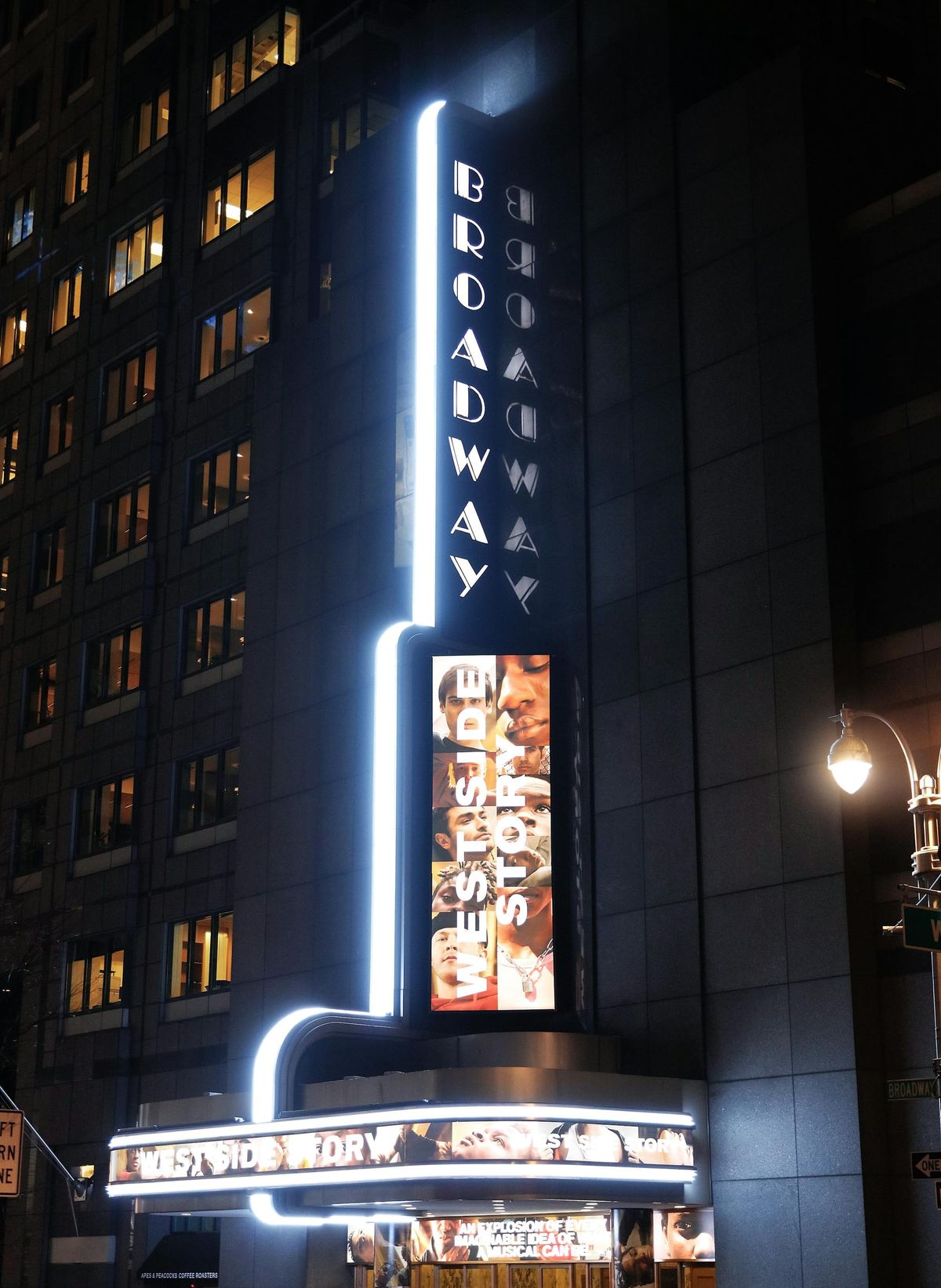 Illuminated Broadway theater signage at night in New York