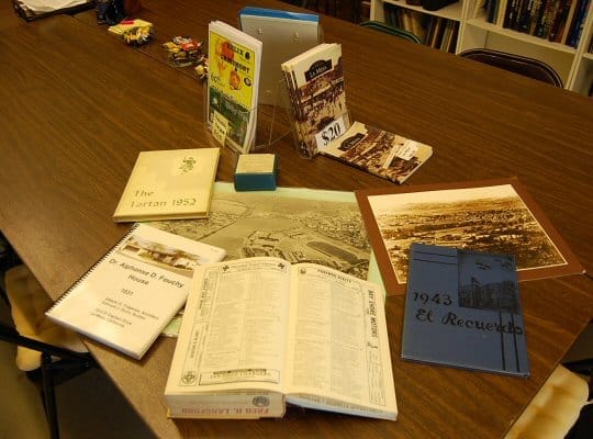 Books and aerial photos spread out on a table