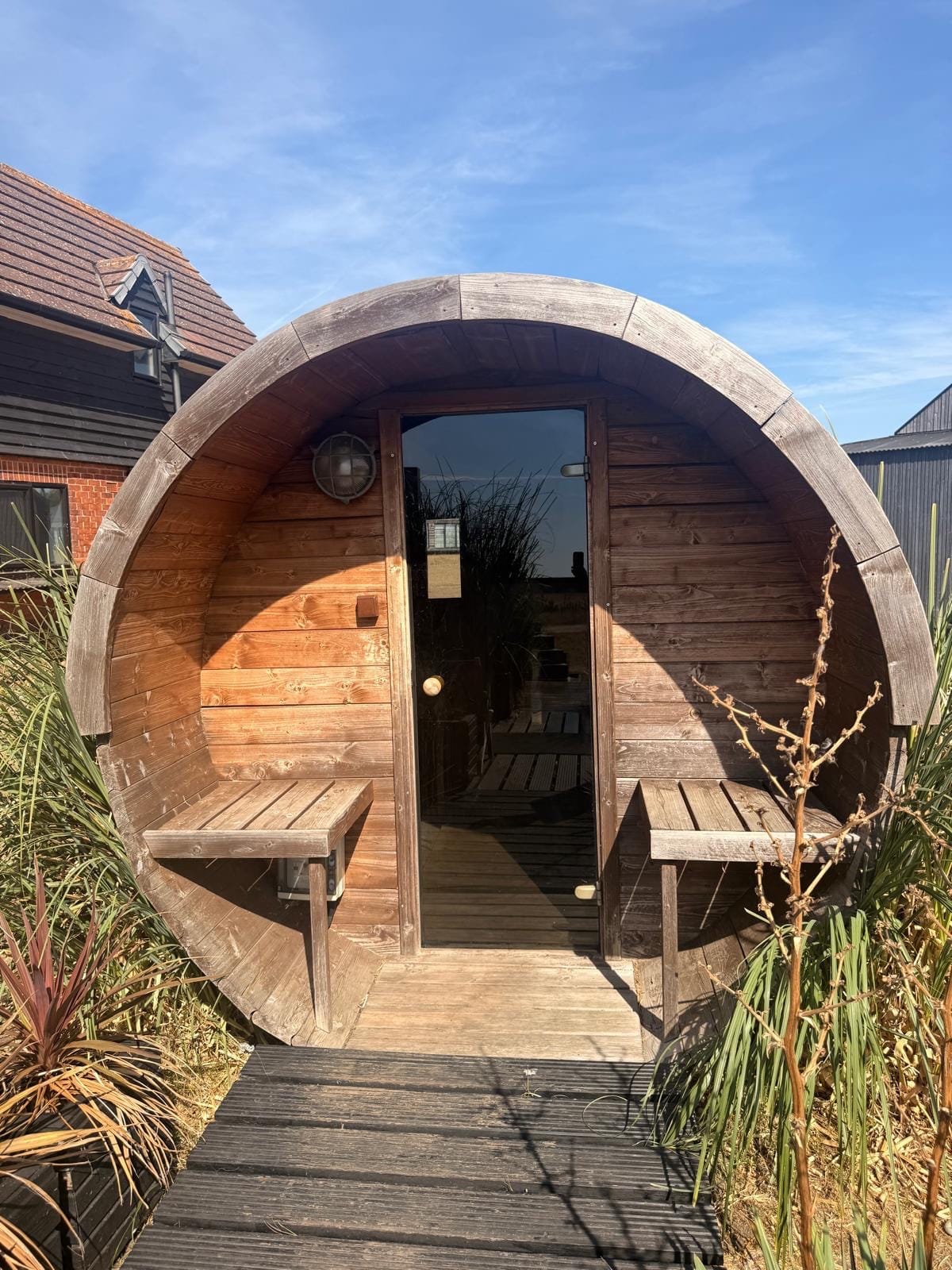 Wooden barrel sauna on planted decking in the spa area at Cabu by the Sea, Dymchurch
