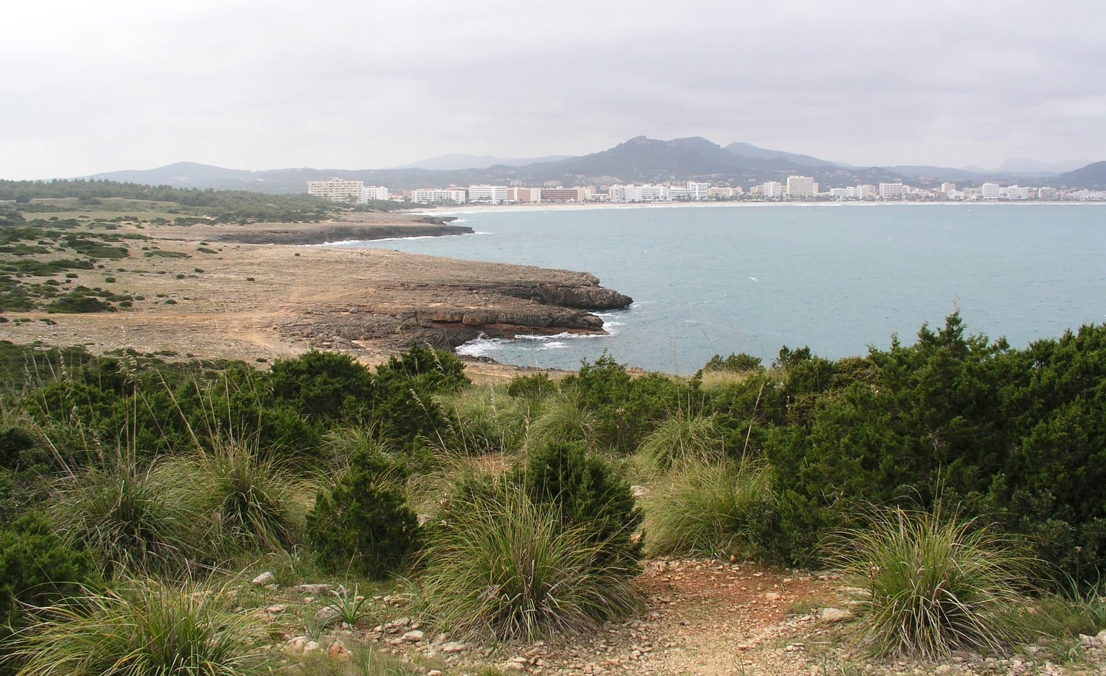 Cala Millor bay and hotel strip seen across scrubland from the Punta de n'Amer headland