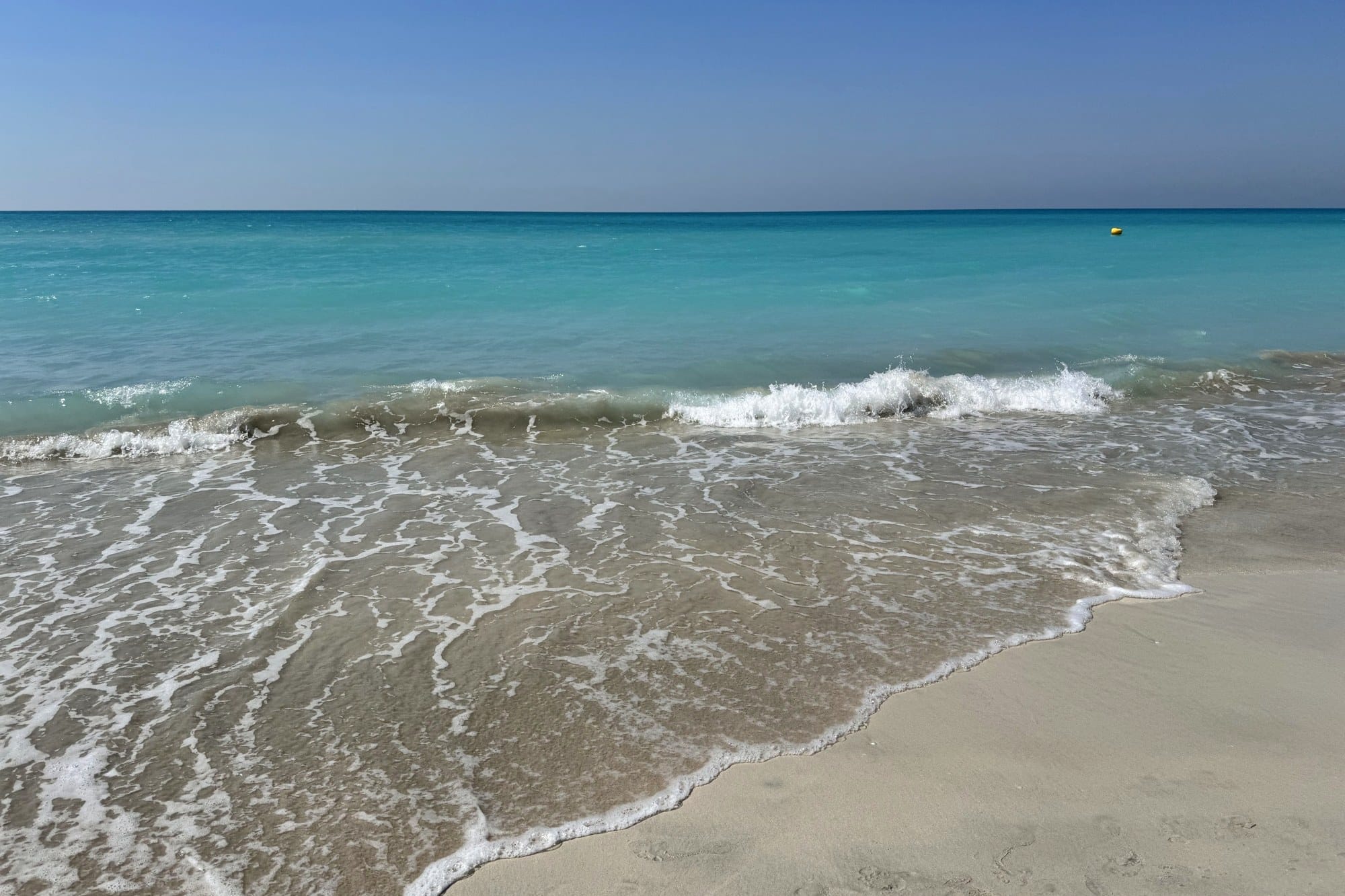 Turquoise sea and pale sand on the private beach at Saadiyat Island, Abu Dhabi