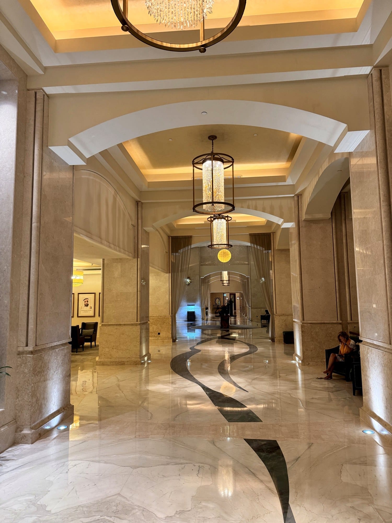 Marble lobby with arched ceilings and chandeliers at a five-star Saadiyat Island resort
