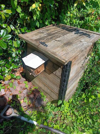 Notre bac à compost au fond du jardin, assorti la maisonnette à abeilles maçonne BeeHome positionnée sur l'une de ses faces