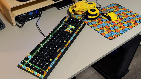 Desk with pokemon keyboard, headset, mouse, and mousepad
