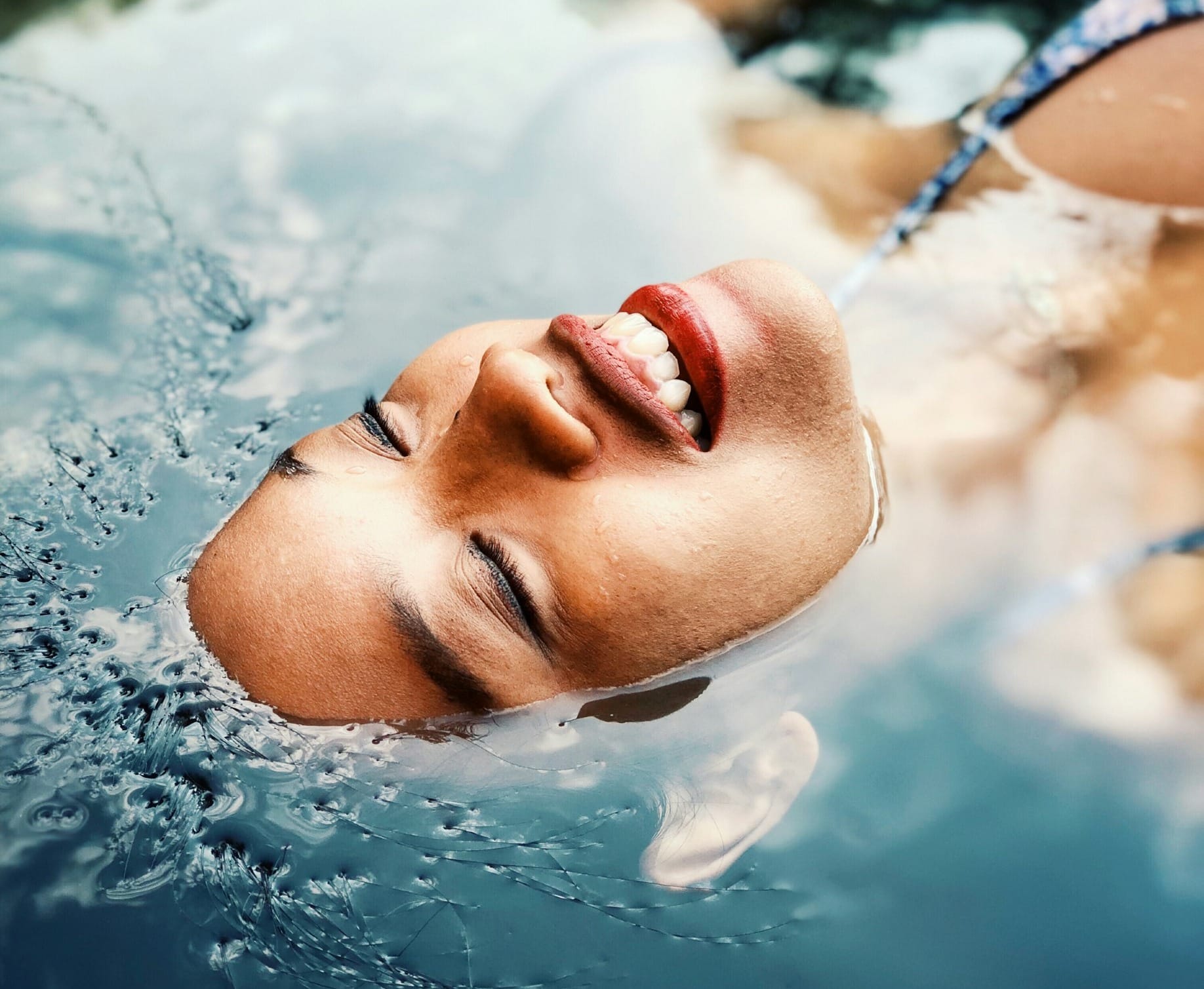 floating woman on body of water