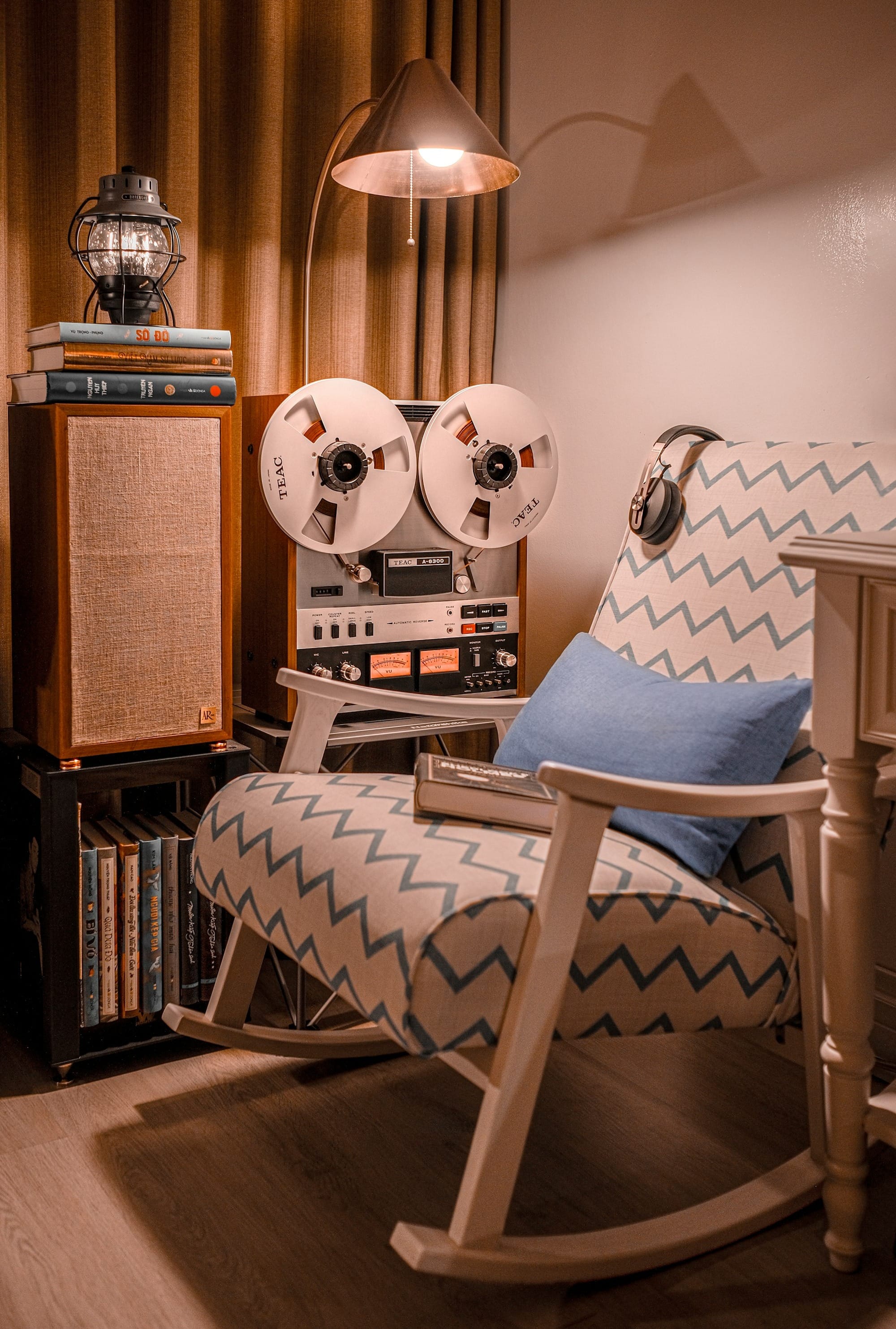 a rocking chair in a living room next to a record player