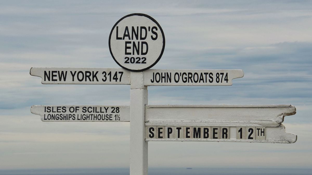 A signpost with multiple directional arrows against a bright sky.