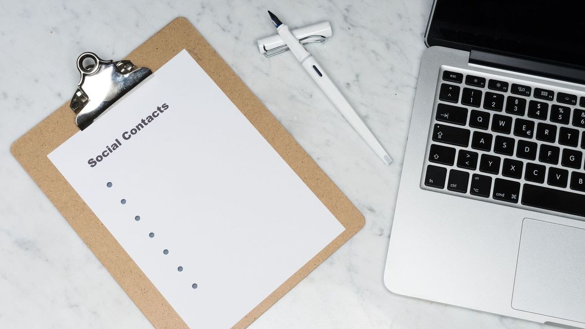A clipboard with a short checklist sits beside a laptop and pen on a desk.