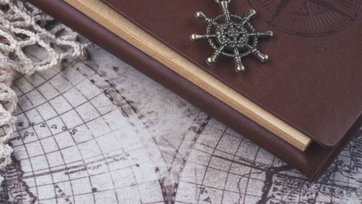 A notebook resting on a paper map.