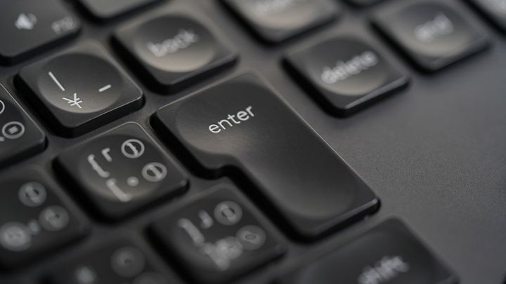 Close-up of the Enter key on a black keyboard.