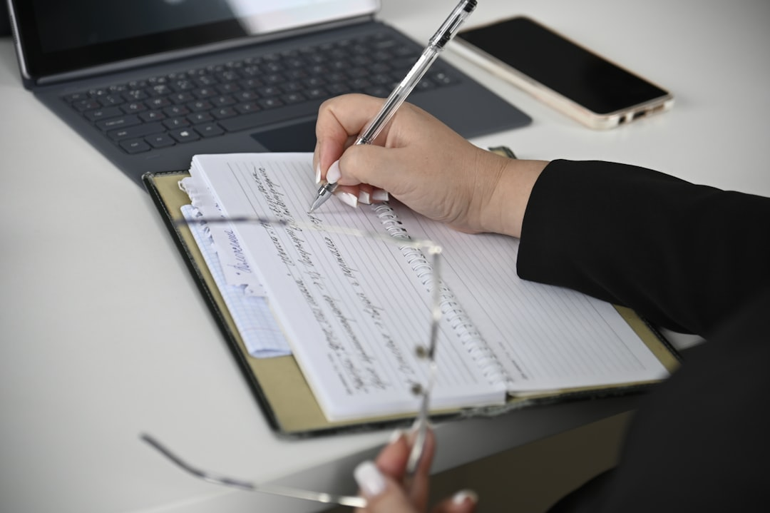 business contracts on desk with laptop and pen