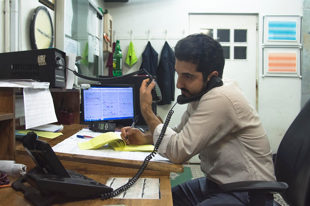 small business owner using laptop phone
