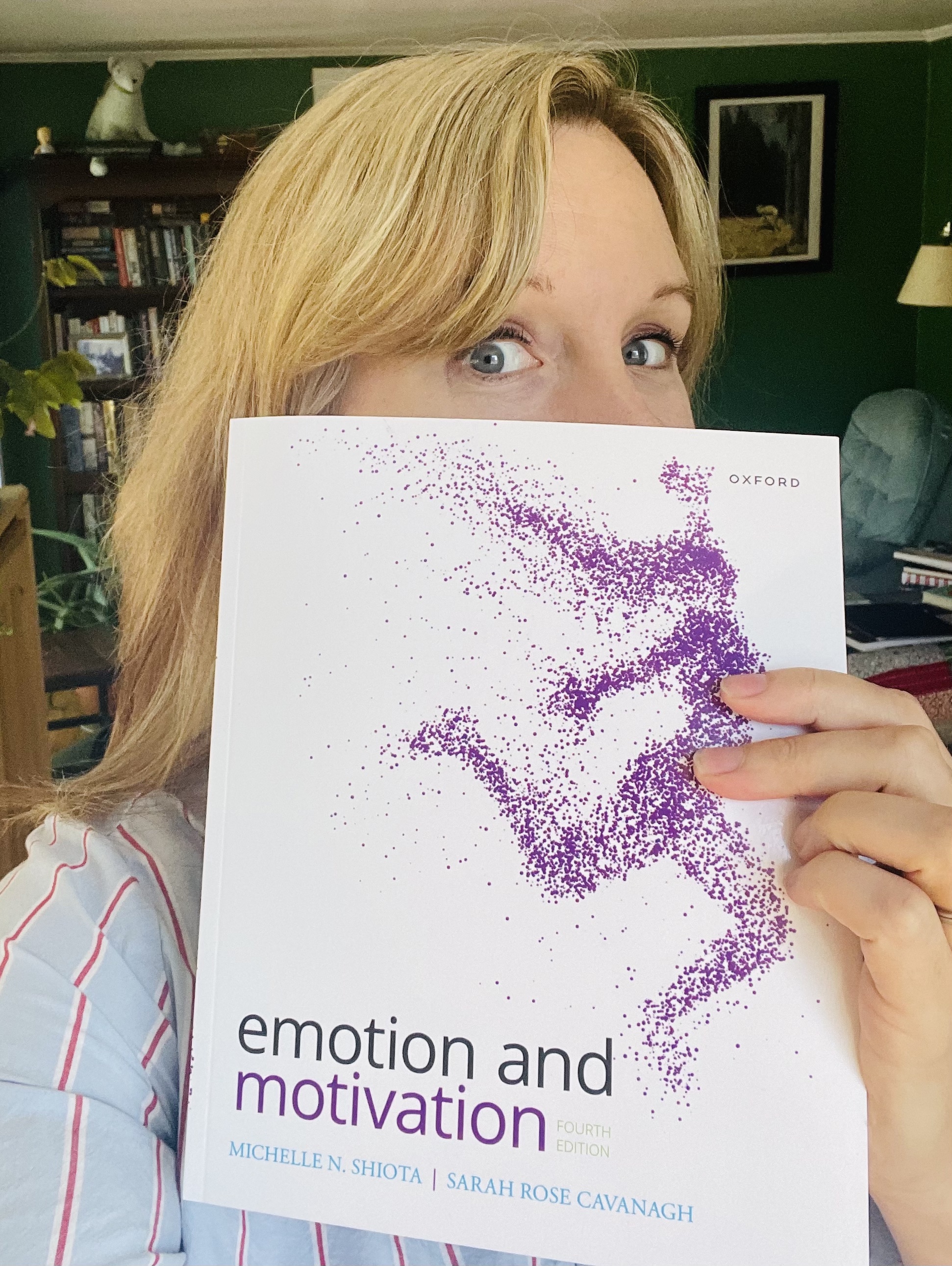 Author peeking over the book