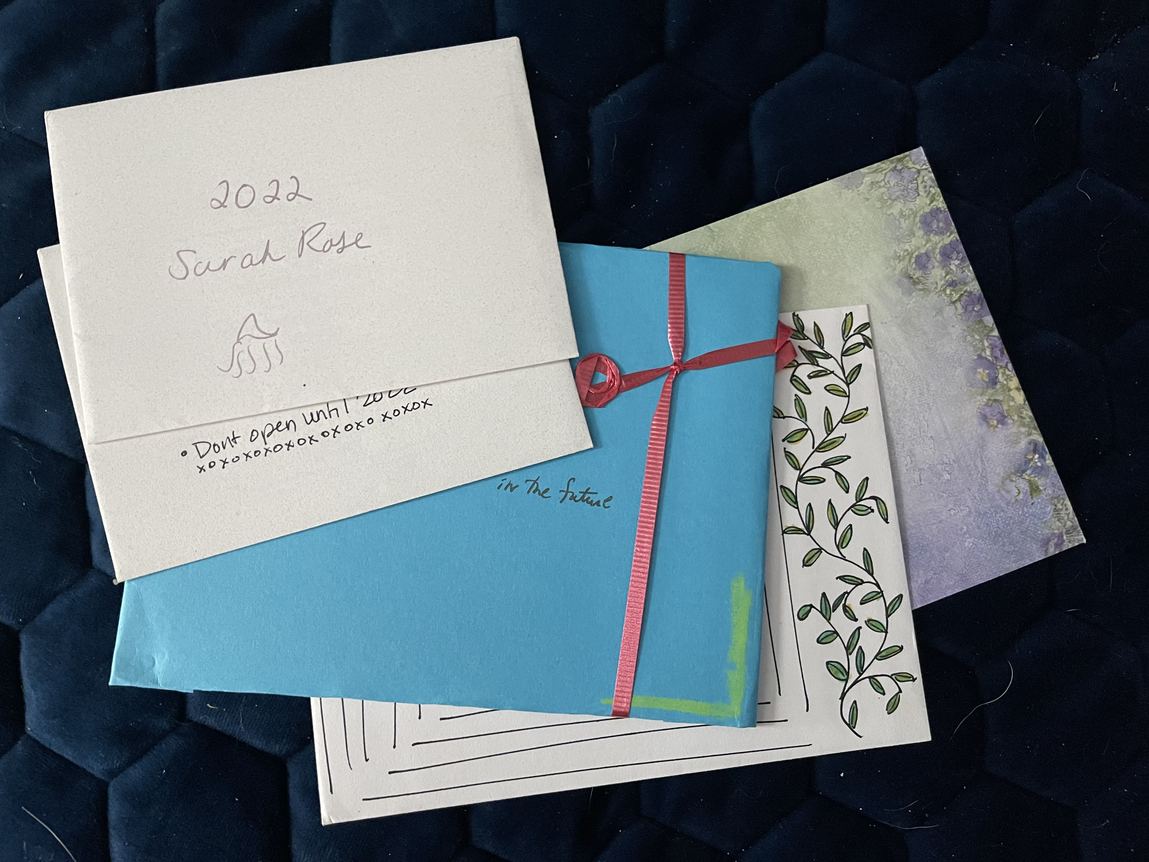 Several cards in envelopes, the top which reads: 2022 Sarah Rose.